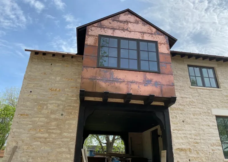 Copper metal panel facade on a stone building for Skylight Installation in Carencro
